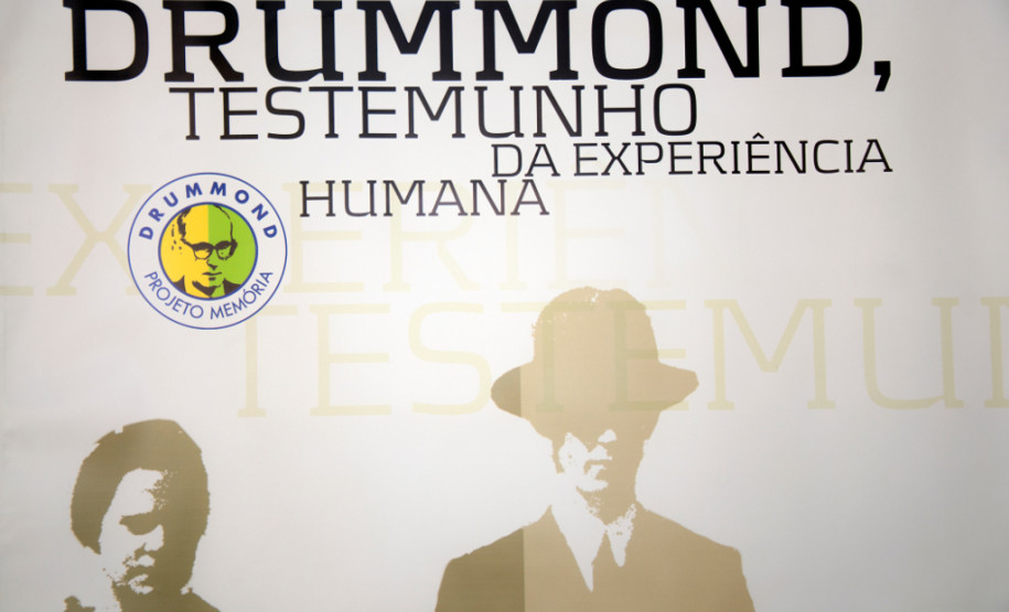 Poesia de Carlos Drumonnd percorre escolas estaduais Exposição itinerante leva 15 banners de dupla face com biografia e principais textos do poeta para escolas que trabalham a obra de Drummond.