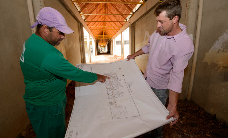 Leonir Noronha, encarregado das obras da nova sede do Colégio Estadual José Orestes Preima, mostra a planta da obra para o diretor do colégio, José Adriano Iulek. Prudentópolis, 14/05/2013.